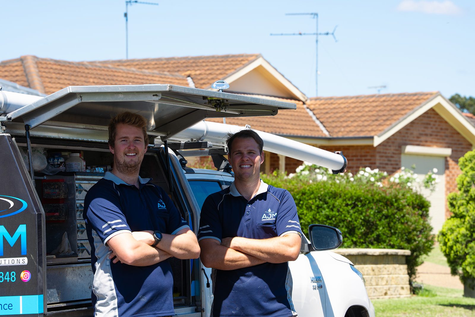 The AJM Plumbing Solutions team at the van