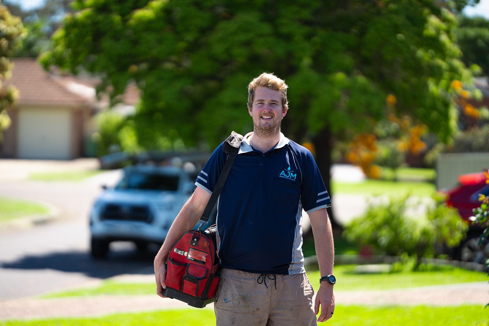 Aaron from AJM Plumbing Solutions arriving on site with his tool bag